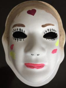 Unmasking Brain Injury mask painted with a face