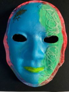 Unmasking Brain Injury mask painted with blue, green and red