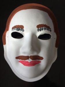 Unmasking Brain Injury mask painted with a face with a mustache