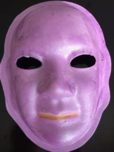 Unmasking Brain Injury mask painted purple with orange lips