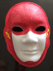 Unmasking Brain Injury mask painted in red and white with yellow designs