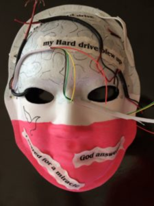 Unmasking Brain Injury mask painted with red and white sections with text