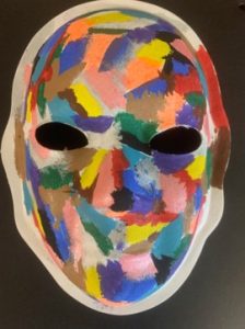 Unmasking Brain Injury mask painted with numerous color splotches