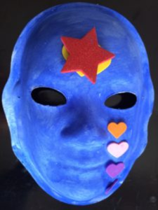 Unmasking Brain Injury mask painted blue with felt hearts and a red felt star