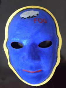 Unmasking Brain Injury mask painted blue with the word "fog" painted on it