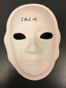 Unmasking Brain Injury mask painted with the word "calm"