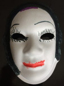 Unmasking Brain Injury mask painted with a face with eyelashes, eyebrows, hair and lips